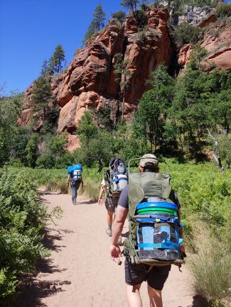 Volunteers backpacking in Oak Creek Canyon.